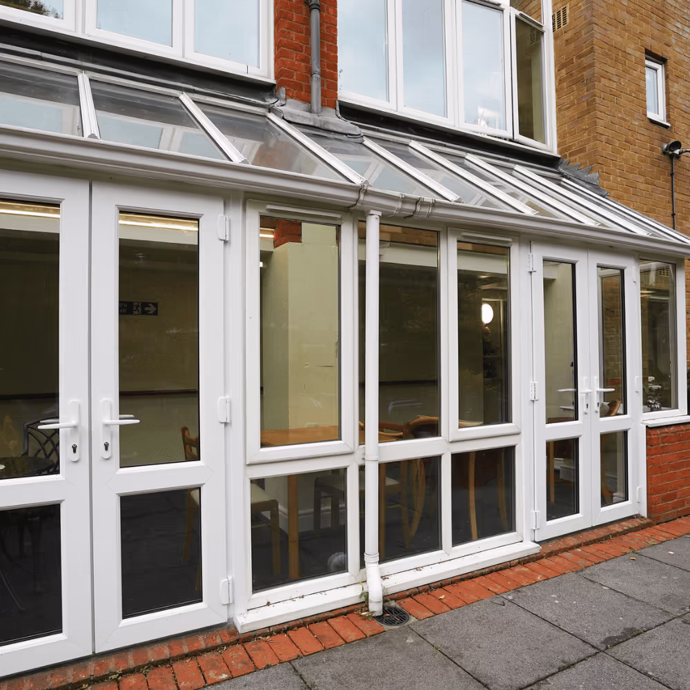 The new white UPVC conservatory installed at the residential facility, providing a bright and modern communal space for residents.