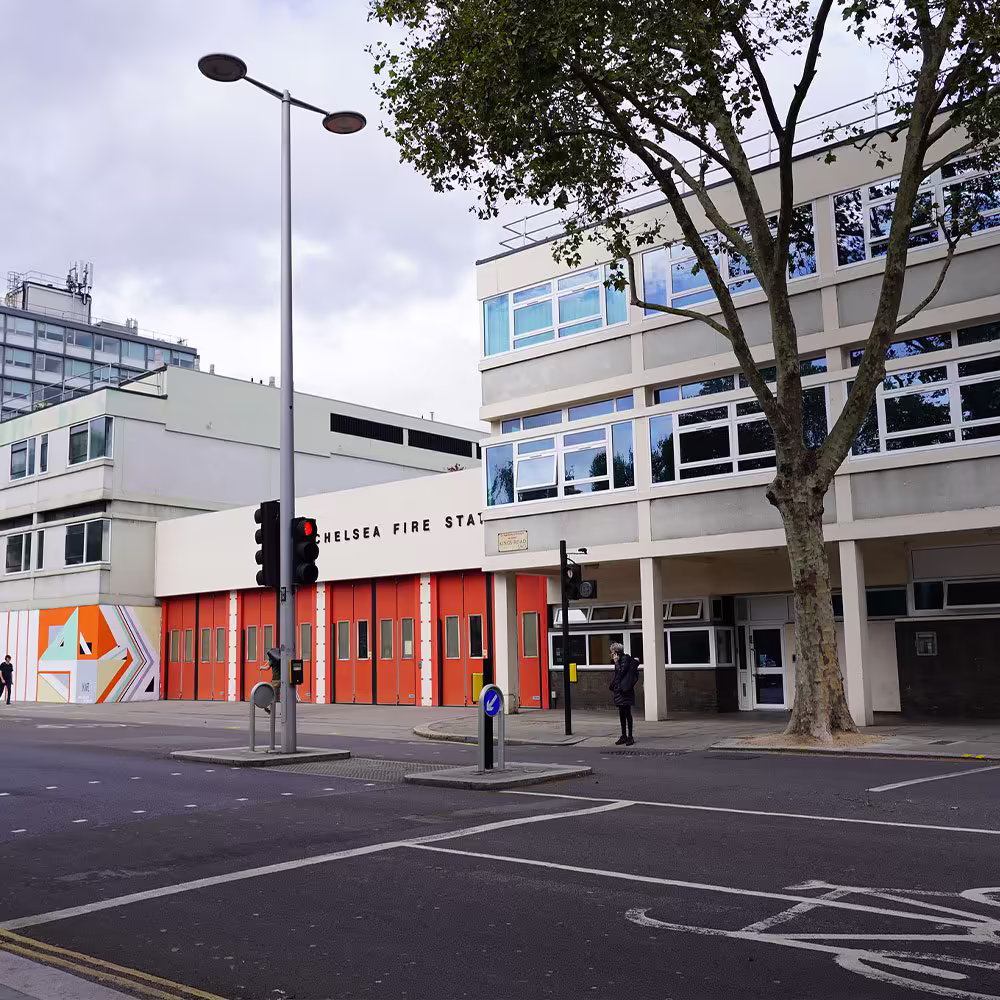 Operative removing an old window unit from a brick property during the renewal project.