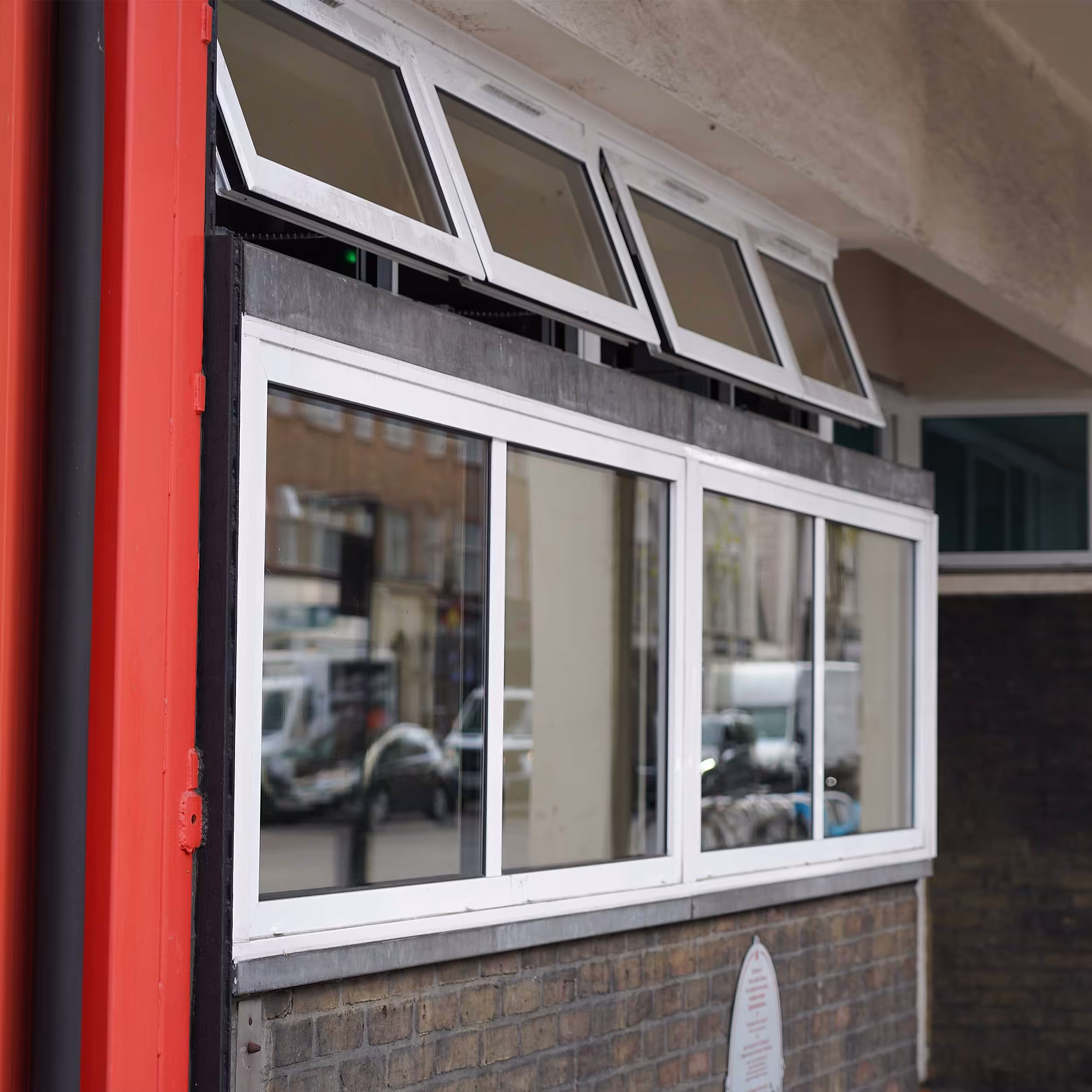 Completed replacement showing a new white-framed window fitted flush within the brick façade.