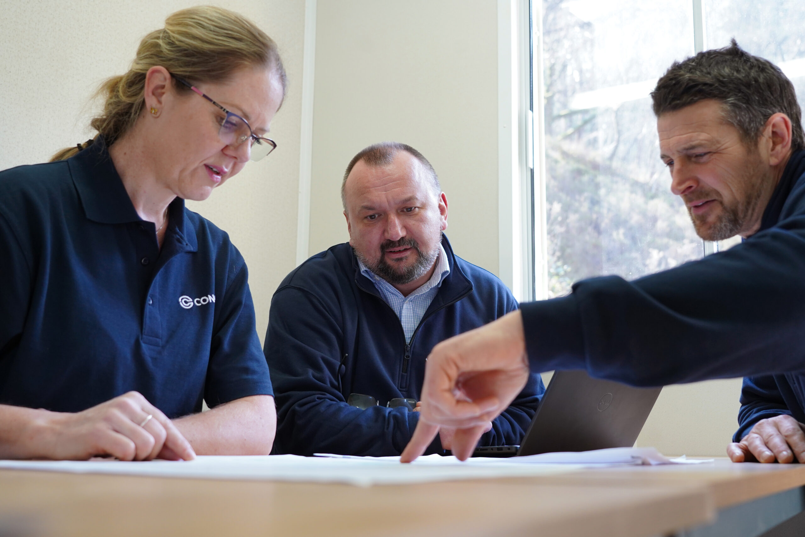 Colleagues engaging in conversation at a project site, representing equality in the workplace.