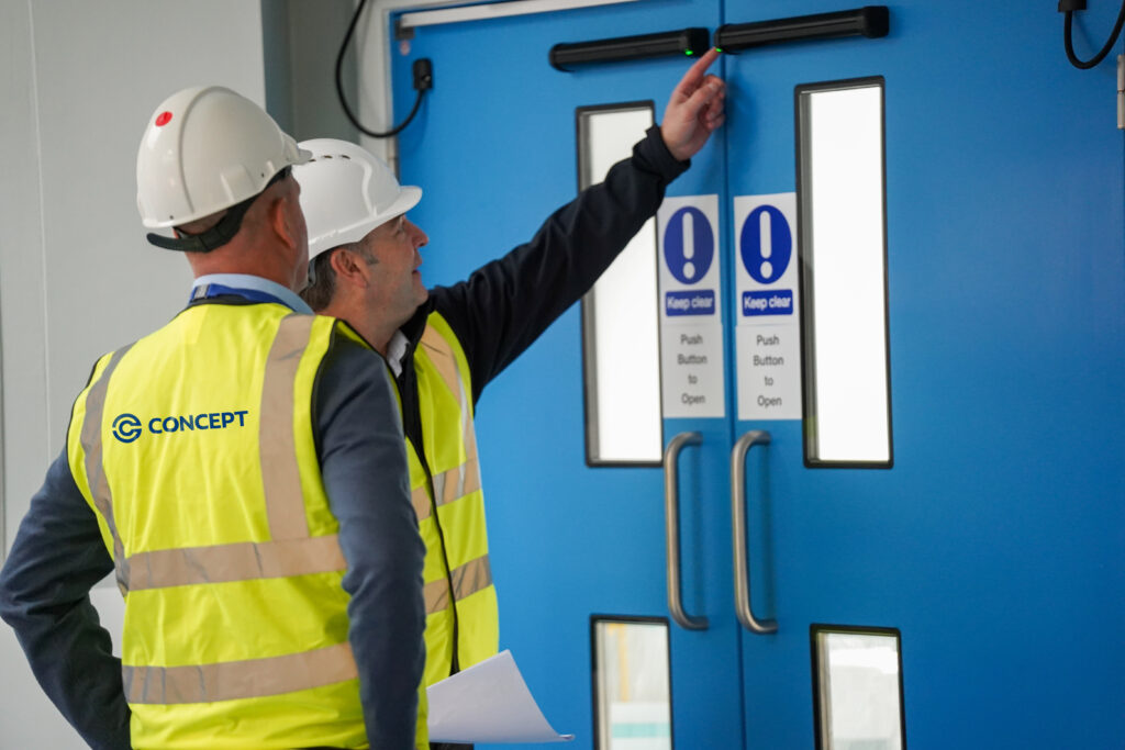 Two colleagues inspecting the high quality door installations in a NHS estate.